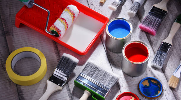 Paint can and paintbrushes of different size for home decorating purposes.
